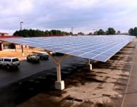 A large solar panel sitting on top of concrete.