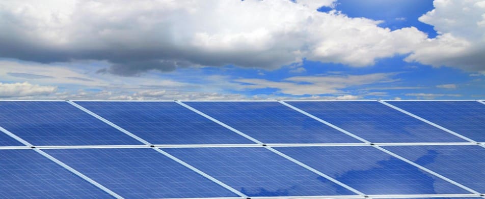 A close up of the solar panels on top of a roof.